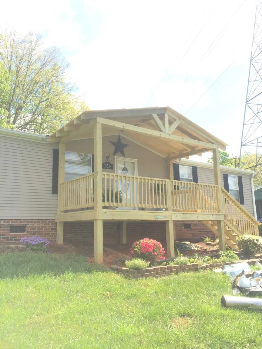 New gabled porch roof and deck railing added to a ranch home in Lanesborough